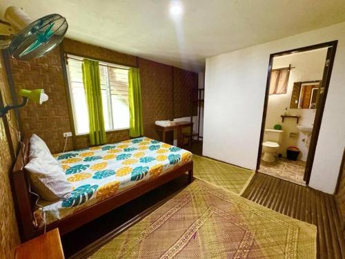 a bedroom with a bed and a bathroom with a mirror at White Knight Double Family Room in San Juan
