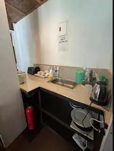 a kitchen with a sink and a counter top at White Knight Double Family Room in San Juan