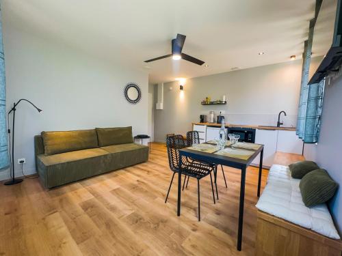 a living room with a couch and a table at SERENITY Suite in Vénissieux