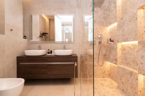 a bathroom with two sinks and a shower at Villa Romana - Luxury Estate in Stomorska