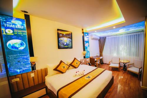 a hotel room with a bed and a large screen at MEDDOM Park in Cao Phong