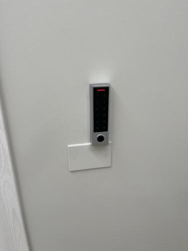 a remote control hanging on a white wall at Therma Luxury house in Termoli
