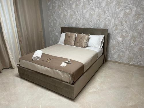 a bed with a phone on it in a bedroom at Therma Luxury house in Termoli