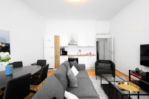 a living room with a couch and a table at OrestaLiving - BrigittineurLände in Vienna