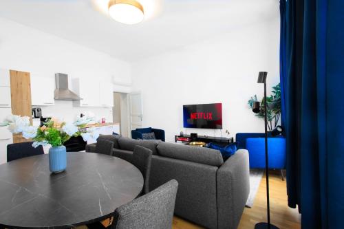 a living room with a table and a couch at OrestaLiving - BrigittineurLände in Vienna