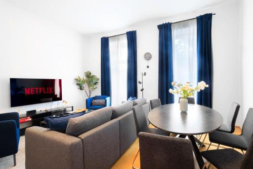 a living room with a couch and a table at OrestaLiving - BrigittineurLände in Vienna