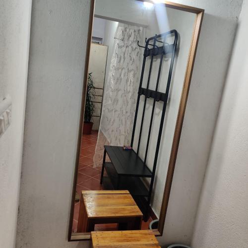 a mirror with a table and a bench in a hallway at The Sattva Nature Retreat in Avathi