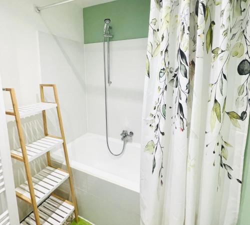 a bathroom with a shower and a shower curtain at Grand Bleu, Vue sur Lac, Cosy et Chic WIFI Centre ville, Plage in Istres