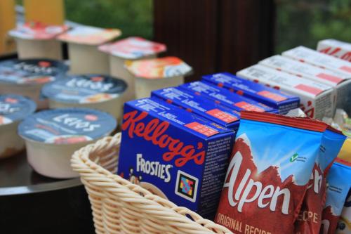 a table with a basket of toothbrushes androzen food at Cairnview Bed and Breakfast in Larne