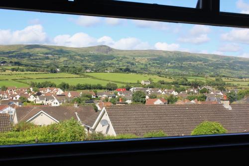 a view from a window of a town with hills at Cairnview Bed and Breakfast in Larne