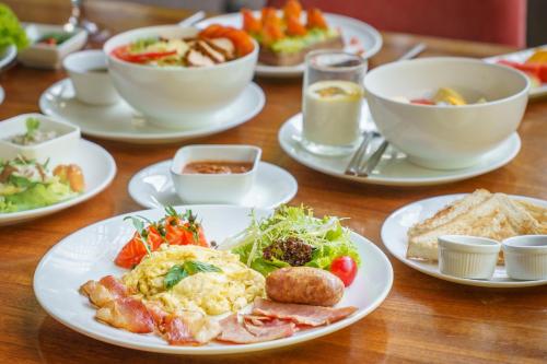 a table with plates of food and bowls of food at Viroth's Villa in Siem Reap