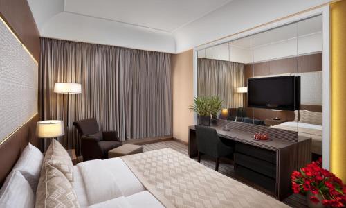 a hotel room with a bed and a television at Dan Jerusalem Hotel in Jerusalem