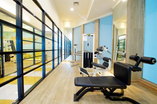 a gym with two treadmills and a simulator at Tongtara Riverview Hotel in Bangkok