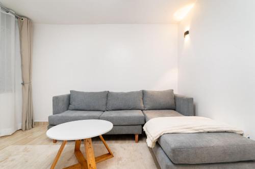 a living room with a couch and a table at Serene Homes in Ruiru