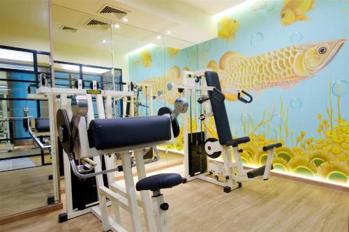 a fitness room with a gym with a fish mural at Tongtara Riverview Hotel in Bangkok