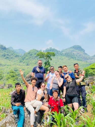 a group of people posing for a picture on a mountain at Strawberry House , Tour & Motorbikes Rentel in Ha Giang
