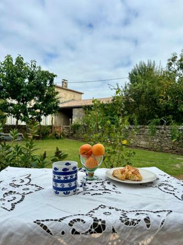 a table with a plate of food and oranges on it at Studio 25m 2 lits in Gauriaguet