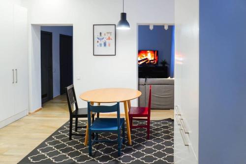 a dining room with a table and four chairs at Cozy sweet home in Rīga