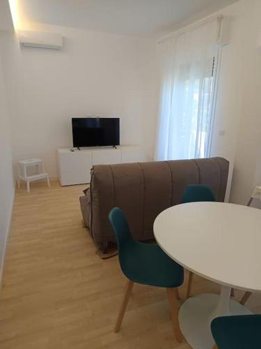 a living room with a couch and a table at Accogliente Bilocale -parcheggio privato- in Sanremo