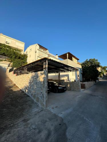 a car parked in a parking lot next to a house at Apartment Block Two in Šibenik