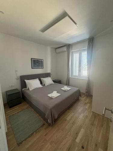 a bedroom with a bed with two towels on it at Apartment Block Two in Šibenik