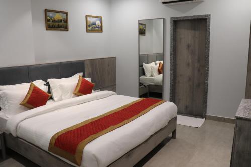 a bedroom with a large bed and a mirror at The Byke Boutique - Amra Oasis Osian in Osiān