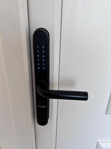 a black door handle on a white door at Villa Ana - Charming Appartments in Belgrade