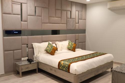 a bedroom with a large bed with white sheets and pillows at The Byke Boutique - Amra Oasis Osian in Osiān