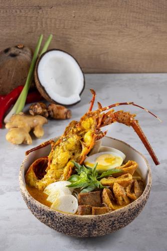 a bowl of food with a shrimp and other foods at Mandarin Oriental, Jakarta in Jakarta
