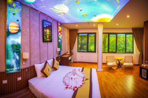 a bedroom with a large bed with a ceiling with planets at MEDDOM Park in Cao Phong