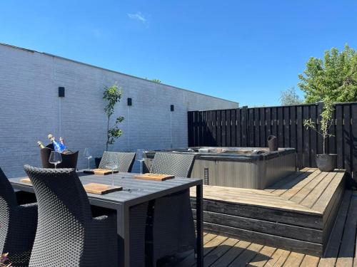 a patio with a table and chairs and a grill at Wellness House in Frederikssund