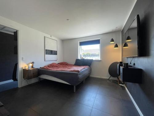 a bedroom with a bed and a window in it at Wellness House in Frederikssund