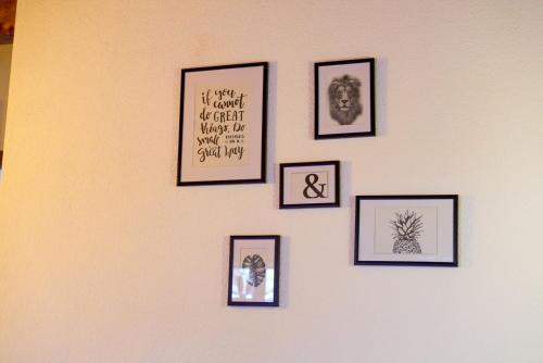 a group of pictures on a wall at Chez Cathy chambre chez l'habitante in Bremis