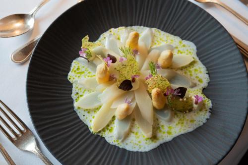 a plate of food with a flower on it at Wellnesshotel ...liebes Rot-Flüh in Haldensee