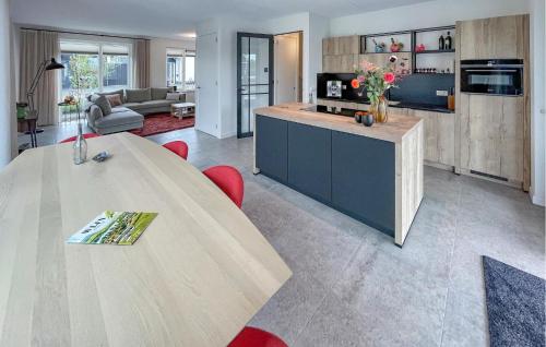 a living room with a large table and a couch at 3 Bedroom Awesome Home In Stavoren in Stavoren