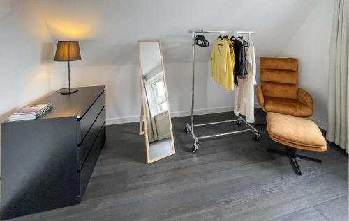 a dressing room with a dresser and a mirror at 3 Bedroom Awesome Home In Stavoren in Stavoren