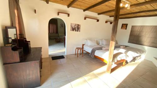 a bedroom with a bed in the middle of a room at Wide Horizons Mountain Retreat in Malkerns
