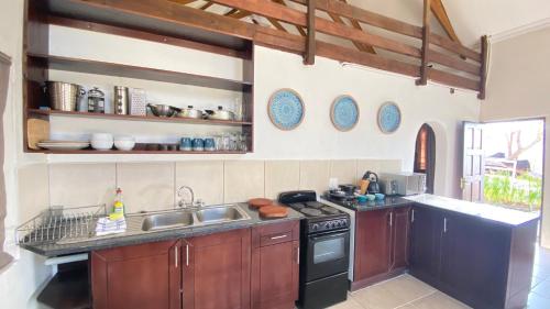 a kitchen with a sink and a stove at Wide Horizons Mountain Retreat in Malkerns
