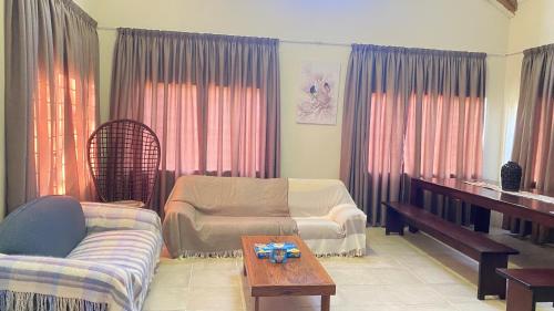 a living room with a couch and a table at Wide Horizons Mountain Retreat in Malkerns