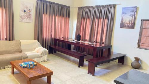 a living room with a couch and a table at Wide Horizons Mountain Retreat in Malkerns