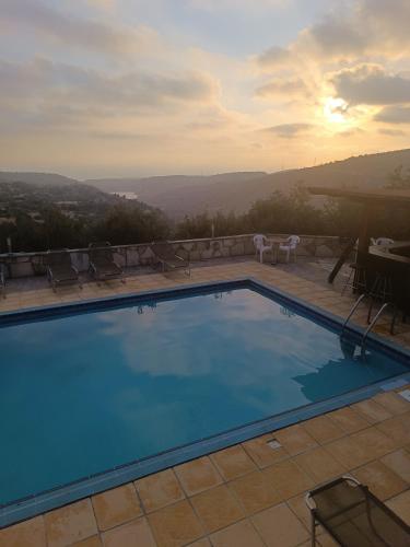 a swimming pool with a view of the mountains at Glamping Adonis in Paphos