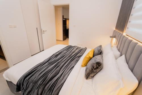 a bed with pillows on it in a room at Sharjah apartment by Stay Bnb in Sharjah