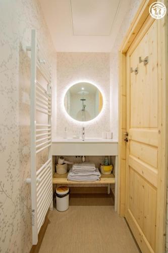 a bathroom with a sink and a mirror at Le Domaine de la Source in Chauffailles