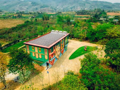 a house with a solar roof on top of it at MEDDOM Park in Cao Phong