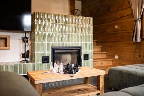 a living room with a fireplace and a coffee table at Roubenka Sobotín in Sobotín
