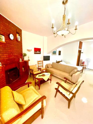 a living room with a couch and a fireplace at Irene Villa in Ierápetra