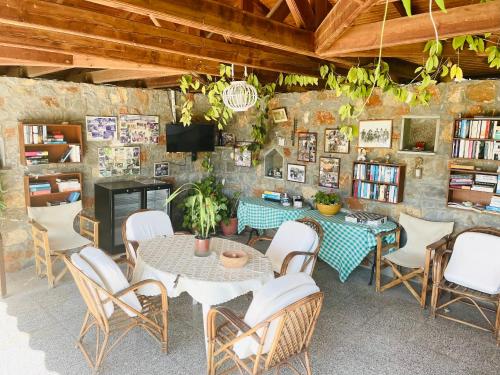 a room with a table and chairs and a tv at Irene Villa in Ierápetra