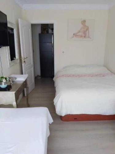 a hotel room with two beds and a desk and a bed at Room Centro shared bathroom Wifi in Santander