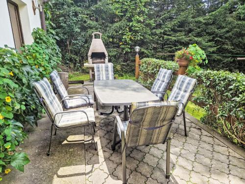 a patio with a table and chairs and a grill at Holiday Home Horní Lánov by Interhome in Horní Lánov