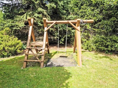 a wooden swing set sitting in a yard at Holiday Home Horní Lánov by Interhome in Horní Lánov